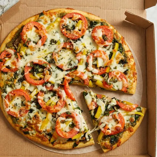 Butter chicken pizza topped with creamy butter chicken sauce at Pizza Blvd Brampton West